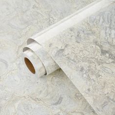 a roll of white marble paper sitting on top of a floor