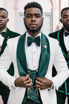 three men in green and white tuxedos standing next to each other with their hands on their hips