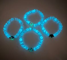 This glow in the dark bracelet is designed using 8mm crystal glass beads and one 10mm  lamp work glass bead in the center of the bracelet.  This bracelet will appear transparent in the daylight.  Expose it to bright light for a few minutes and it will glow when you enter a dark room or outside at night.  The longer you expose your jewelry to bright light the longer and brighter you will  enjoy the glow! In the dark your bracelet will simply amaze you!    This piece is offered in clear with your Glow In Dark Bracelet, Glow In The Dark Bracelets, Luminous Round Bead Jewelry For Gifts, Luminous Round Beads Jewelry Gift, Luminous Round Beads Jewelry For Gift, Neon Beaded Bracelet Gift, Neon Beaded Bracelets Gift, Neon Bracelets With Round Beads For Gift, Neon Round Bead Bracelets For Gifts