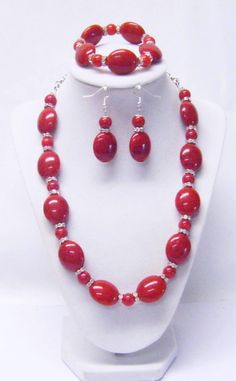 "Red Oval/Round Acrylic w/Wavy Rhinestone Bead Necklace/Bracelet/Earrings This necklace set is made with big, beautiful, red oval acrylic beads, 10mm round acrylic beads and wavy Rondelle crystal rhinestones beads strung on flexible beading wire and finished off with silver chain. It us 21 ½\" in length and fastens with silver lobster clasp. It comes with bracelet and earrings that hang from silver fish hook ear wires. Necklace Length: 21 ½\" Earrings Length: 2 ½\" (including ear wires) Bracelet Chunky Bead Necklaces, Orange Wood, 2 Earrings, Purple Rhinestone, Chunky Beads, Beading Wire, Rhinestone Bead, Bead Stringing, Wire Bracelet