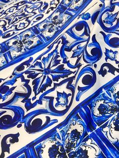 blue and white tiles with designs on them