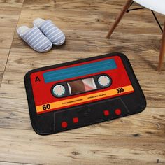 a pair of slippers sitting on top of a wooden floor next to a rug