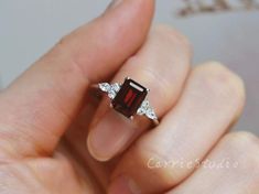 Emerald Cut Natural Garnet ring, made with 925 sterling silver, plated with white gold, beautiful promise ring, special gift for anniversary.Main Stone: Natural GarnetCut: EmeraldMeasurerment: 6*8 mm Side Stone: CZCS0328 Beautiful Promise Rings, Garnet Ring Silver, Garnet Engagement Ring, Stackable Rings Wedding, Red Garnet Ring, Mom Ring, Diamond Cluster Engagement Ring, Alexandrite Engagement Ring, Topaz Engagement Ring