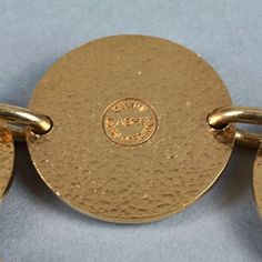 Features: - 100% Authentic CELINE PARIS. - Alternate beige enamel Celine horse carriage logo and plain gold tone medallions.. - Gold tone hardware. - Toggle closure. - Signed CELINE ABH1 Made in France. - Slip on bracelet. - Minor surface scratches. - Good vintage condition. Measurements: Height: 1.22 inches (3.1 cm) Wearable Length: 7.68 inches (19.5 cms) **This bracelet will be shipped via Priority Shipping with tracking number. Please convo me for any queries and additional photos. Thank you Celine Paris, Vintage Celine, Horse Carriage, Charm Bracelets, Link Bracelets, Made In France, Tracking Number, Gold Tones, Charm Bracelet