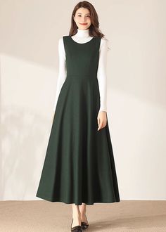 "★★ FEATURES * 30% wool, other fiber, nylon * Polyester lining * Two side pockets * Back zipper closure * Sleeveless * Fitted waist dress * Maxi wool dress * Winter wool dress * Perfect for Winter, autumn * Dry clean * White blouse is not sale items ★★ The model is 170 cm (5′ 7″) tall with a 80 cm (31.5\") bust, 66 cm (26\") waist. She is wearing the wool dress in size XS. ★★ Bespoke Order Service If you Request other color Request the length Request a sleeve Your height is not between 155 cm- 1 Sleeveless Wool Dress, 1950s Wool Dress, Winter A-line Maxi Dress, Green Sleeveless Dress For Fall, Elegant Sleeveless Winter Midi Dress, Chic Sleeveless Winter Dress, Solid Sleeveless Dress For Fall, Solid Sleeveless Dresses For Fall, Sleeveless Dresses With Pockets For Fall