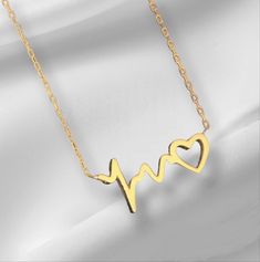 10K 14K 18K Gold Heart Rhythm Necklace, Gold Heart Necklace, ECG Sound Wave Necklace. Handmade Heart Necklace, Christmas Gift, Mother's Day Gift. All jewelry in our collection are real solid gold and completely handmade accessories. The jewelry in our collection, which is an accessory with a bright and eye-catching beauty that will make others notice you and your loved ones in the environments you enter, is a great gift option to add value to the people you care about on special occasions. * Han Yellow Gold Heart Necklace Gift For Her, Yellow Gold Heart Necklace For Her, Gold Plated Double Heart Necklace For Mother's Day, 14k Gold Heart Pendant Necklace For Gift, 14k Gold Open Heart Necklace For Gift, Rose Gold Jewelry With Heart Beads For Anniversary, Gold Double Heart Necklaces For Her, Heart Shaped Clavicle Chain For Anniversary, Gold Plated Heart Beaded Necklace For Anniversary