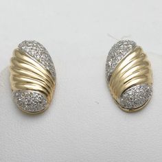 "This is a stunning pair of vintage diamond earrings! These earrings are made of 14k yellow and white gold. They are stud earrings that are oval in shape and mostly yellow gold with a beautiful groove swirly design on the yellow gold part. The top and bottom of each earring is filled with pave set diamonds. The are very nice quality diamonds, white and sparkly, G-H in color and VS2-SI1 in clarity. The total carat weight is approximately 0.80 carats. They are posts with nut backings for pierced e Gold Oval Diamond Earrings With Accents, Gold Oval Diamond Earrings, Oval Yellow Gold Earrings With Diamond Accents, Oval Diamond Earrings With Pave Setting For Anniversary, Classic Oval Diamond Earrings With Pave Setting, Oval Diamond Earrings In Pave Setting, Oval Diamond Earrings With Pave Setting In White Gold, Oval Yellow Gold Diamond Earrings For Anniversary, Classic 14k Stamped Diamond Earrings