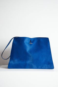 Royal Blue Phoebe Philo era ponyhair shoulder bag with toggle closure. Two main compartments with zip closure middle compartment and four side pockets Luxury Blue Top Handle Hobo Bag, Luxury Blue Hobo Bag With Top Handle, Luxury Blue Hobo Bag For Travel, Rectangular Bucket Bag With Palladium Hardware For Daily Use, Blue Satchel With Palladium Hardware, Pouch Shoulder Bag With Palladium Hardware, Blue Crossbody Bag With Palladium Hardware, Blue Satchel Shoulder Bag With Palladium Hardware, Everyday Pouch Shoulder Bag With Palladium Hardware