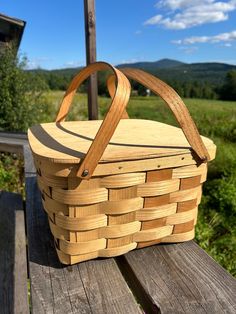 a basket sitting on top of a wooden bench