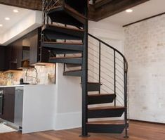 a spiral staircase in the middle of a kitchen