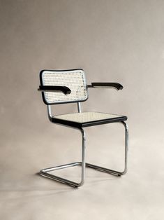 a chair with an arrow on the back and armrests is shown in front of a gray background