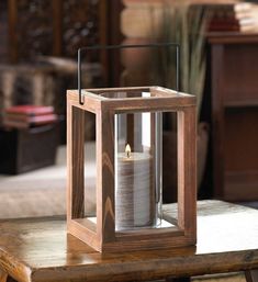 a wooden lantern sitting on top of a table