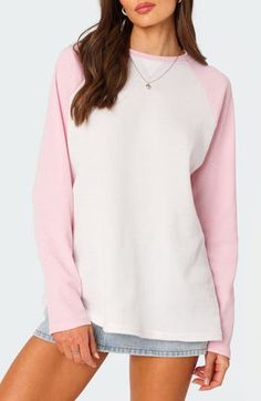 This cozy waffle-knit top is crafted in an oversized fit and framed by sporty raglan sleeves. Crewneck Long sleeves 50% cotton, 50% polyester Machine wash, dry flat Imported Casual Pink Sweater With Ribbed Cuffs, Pink Color Block Sweatshirt For Spring, Pink Color Block Tops For Loungewear, Spring Cotton Waffle Knit Sweatshirt, Cotton Waffle Knit Sweatshirt For Spring, Spring Waffle Knit Cotton Sweatshirt, Oversized Sporty Raglan Sleeve Tops, Cozy Raglan Sleeve Tops For Loungewear, Pink Sporty Sweater For Spring