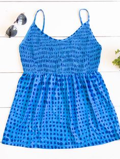 Cute, simple, and stylish... need we say more. The smocked top, beautiful pattern, and soft fabric make this tank stand out in a crowd. Note: Smocking is only on the front of the tank. The back is solid. Size Small 0-4 Medium 6-8 Large 10-12 XL 12-14 Tank Stand, Maxi Skirt Dress, Smocked Top, Graphic Apparel, Say More, Knee Length Dresses, Romper Pants, Knee Length Skirt, Blazer Dress