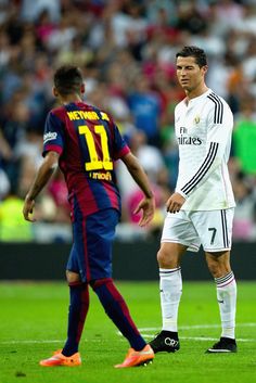 two soccer players are standing on the field