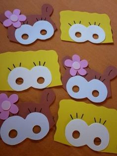 paper masks with flowers on them sitting on a table