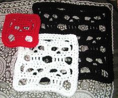 three crocheted doily sitting on top of a white and black table cloth