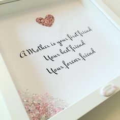 a white box filled with lots of pink and silver confetti next to a card