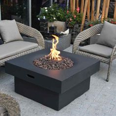 an outdoor fire pit with chairs around it