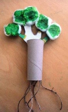 a roll of toilet paper with green trees on it and roots attached to the wall