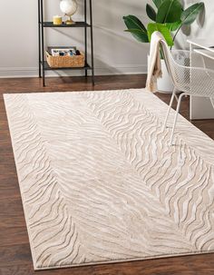 a white rug with wavy lines on it in a living room next to a chair