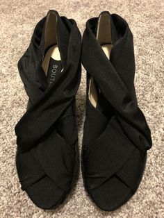 Up for auction is an new (without box) pair of ladies size 7.5 Boutique 9 "Gibsin" fabric, crisscross wedge, open toe shoe. They have never been worn.  In my opinion, these are a bit on the narrow side and run small.  I am a true 7.5 and these are a bit snug. My feedback is 100% positive so you can be sure to bid with confidence.  I strive to ship the same day as payment is received so you will have this item as quickly as possible.  Your item will be shipped via USPS with tracking information p Chic Black Fabric Heels, Fabric Open Toe Wedge Sandals With Platform, Fabric Heels With Wrapped Heel And Round Toe, Evening Wedge Sandals With Wrapped Heel And Closed Toe, Black Fabric Heels With Round Toe, High Heel Fabric Wedge Sandals With Platform, Black Fabric Sandals With Round Toe, Closed Toe Wedge Sandals For Evening, Medium Width, Closed Toe Medium Width Wedge Sandals For Evening