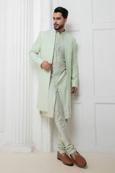 Mint green sherwani jacket with self thread work. Paired with a kurta and churidar. - Aza Fashions Pista Green Nehru Jacket For Designer Wear, Fitted Green Bandhgala With Naqshi Detailing, Fitted Green Bandhgala With Naqshi, Green Fitted Kurta With Naqshi, Fitted Green Nehru Jacket With Dabka Detailing, Green Long Sleeve Bandhgala With Naqshi, Formal Pista Green Sherwani With Chikankari Embroidery, Pista Green Sherwani With Chikankari Embroidery For Formal Occasions, Designer Green Fitted Sherwani