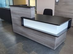 an office desk with a black and white counter top