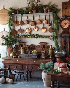 an old fashioned kitchen with pots and pans on the wall