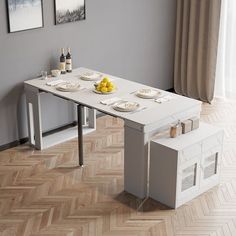 a white table with chairs and plates on it