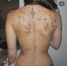 the back of a woman with tattoos on her body