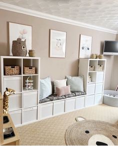 a living room filled with lots of white furniture and storage containers on top of shelves