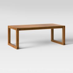 a wooden table sitting on top of a white floor