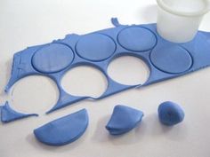 a blue tray with several cups and spoons next to it