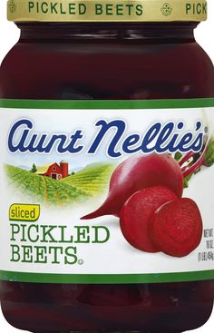 a jar of pickled beets sitting on top of a table