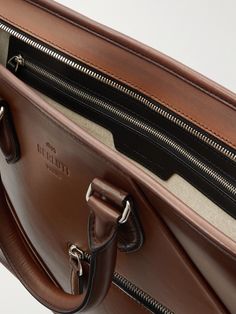 Investing in a smart briefcase, such as this one from Berluti, for important meetings and conferences will help to ensure you make the right impression. It's been made in Italy from the label's signature Venezia leather that will age well over time and unzips to reveal a spacious interior with organisational pockets. Carry it by the top handles or attach the shoulder strap to wear it over your shoulder. Designer Formal Rectangular Laptop Bag, Classic Formal Laptop Bag With Top Handle, Formal Briefcase With Palladium Hardware, Classic Top Handle Laptop Bag For Formal Occasions, Classic Formal Top Handle Laptop Bag, Formal Rectangular Briefcase With Leather Lining, High-end Leather Briefcase For Business, Modern Brown Bag For Business Meetings, High-end Leather Business Briefcase