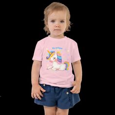 Cute children's shirt made of cotton. This sweet baby shirt features an enchanting unicorn print. Comfortable and also a gift for any little girl or boy. Let your kids run around in this short-sleeved 100% cotton jersey T-shirt with a unique print. The T-shirt is soft, durable and a staple in your child's wardrobe. * 100% combed ring-spun cotton * Fabric weight: 142 g/m² * Pre-shrunk material * Side seam * Relaxed fit for added comfort * Raw product sourced from Honduras or the USA Fun Unicorn Print T-shirt For Summer, Playful Cotton T-shirt With Unicorn Print, Cute Unicorn Print Birthday T-shirt, Playful Cotton T-shirt With Cute Design, Summer Unicorn Print Crew Neck T-shirt, Summer Unicorn Print Crew Neck Top, Casual Unicorn Print T-shirt For Summer, Summer Crew Neck Top With Unicorn Print, Cute Summer Cotton T-shirt