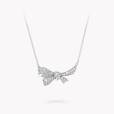 An enchanting Tilda’s Bow pendant in white gold that adorns its wearer with a scintillating sheen of pavé diamonds. The lifelike charm of the motif, as if freshly tied by hand, is brought to life by Graff’s master craftsmen, who imperceptibly set the fluid curves of the bow with radiant stones. The Tilda’s Bow collection features radiant diamond bows, presented upon pendants, necklaces, earrings and rings, alongside expressive high jewellery interpretations of our iconic bow motif. A charming Ti Graff Necklace, Graff Jewelry, Diamond Drop Pendant, Classic Diamond Ring, Pear Shaped Diamond Ring, Diamond Drop Necklace, Bow Pendant, Diamond Bows, High Jewellery