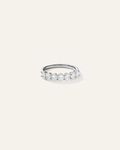 a white gold ring with five diamonds