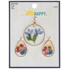 two pendants with flowers on them and the words happy