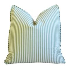 a green and white striped pillow on a white background