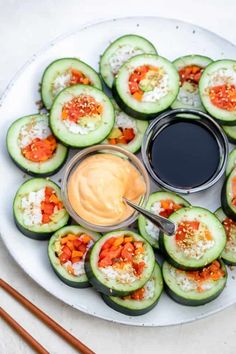 cucumbers are arranged on a plate with dipping sauce