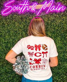 Show off your school spirit with the Corbin Coquette Football T-Shirt! Made with comfy, short sleeve Comfort Colors & regular brand fabric, this t-shirt features a cute bow coquette graphic design on the front and back. Available in two different shirt colors, this shirt is perfect for showing off your love for your local school in a classy yet fun way. Go Redhounds! Unisex sizing + fit Brand: Comfort Colors & Regular Brand Available: White + Gray Marbled T-Shirts Trendy School Spirit Shirts, Boutique T Shirts, Bulldog Mascot Shirts, School Spirit Tees, Cheerleading Tshirt Designs, School Spirit Store Ideas, School Spirit Shirts Designs Elementary, Fccla Shirts Design, Cute School Shirts