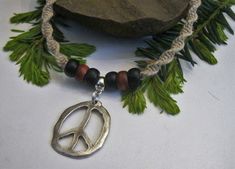 "This hemp necklace design is created using a spiral weave featuring a 1\" x 1.25\" hand hammered pewter peace symbol accented with dark brown and black wooden beads. This necklace is finished with a double loop and wooden bead closure. 15" Jewelry Hippie, Hemp Jewelry, Hemp Necklace, Hippie Necklace, Choker Necklaces, Gift For Friend, Adjustable Necklace, Cord Necklace, Peace Sign