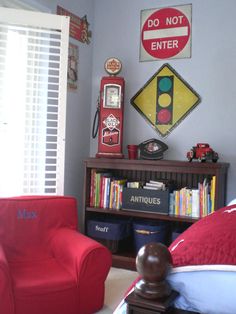 a red chair sitting next to a book shelf filled with books