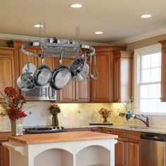 pots and pans hanging from the ceiling in a kitchen