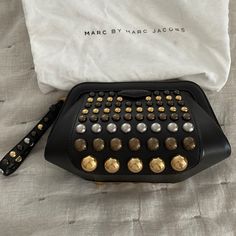 Newer Used, Comes With Dust Bag. Small Zip Pocket Inside, Wrist Strap. Multi-Color Metal Studs. Designer Black Bags With Hardware, Designer Black Bag With Studs, Designer Black Bags With Studs, Designer Black Studded Bag, Studded Clutch, Leather Clutch Purse, Pink Envelopes, Wallet Pouch, Marc Jacobs Bag