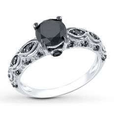 a black diamond engagement ring on a white background