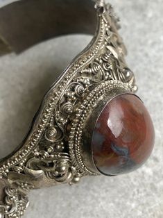 "Old Asian Doubble Dragon 900 Silver Red Marbled Agate Vintage Bracelet marked 90% near the Clasp. weighs 30g. 1 1/2\" wide At the widest The inside Circumstance is 7 1/2\". This bracelet is beautiful and does show age, please view pictures carefully for they are a large part of the description" Traditional Gemstone Cuff Bracelet, Silver Agate Gemstone Cuff Bracelet, Vintage Red Gemstone Bracelets, Unique Red Gemstone Bracelet, Unique Red Gemstone Bracelets, Traditional Agate Bracelet, Traditional Agate Jewelry For Collectors, Traditional Agate Bracelet Jewelry, Artisan Gemstone Bracelets