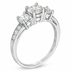 three stone engagement ring with diamonds on the shoulders and side stones set in 18k white gold